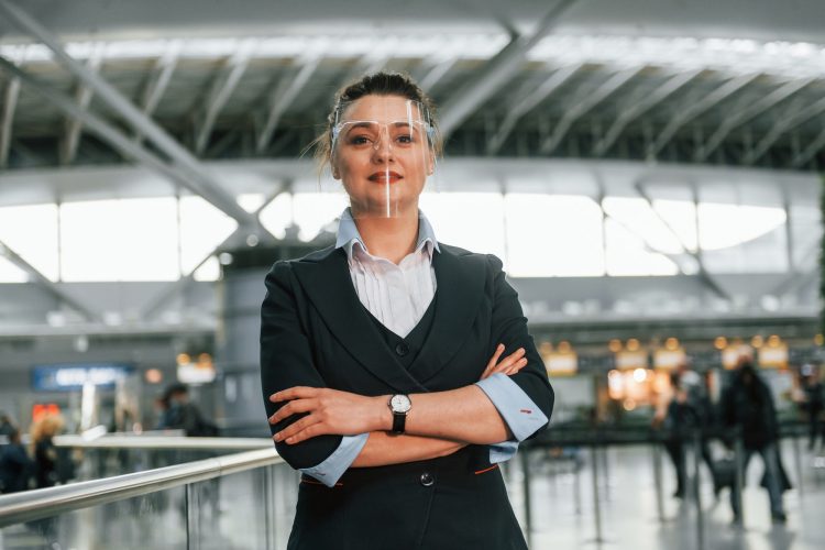 Woman in formal clothes is working in the airport as employee